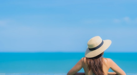 Portrait beautiful young asian woman happy smile relax swimming pool hotel resort neary sea ocean beach blue sky