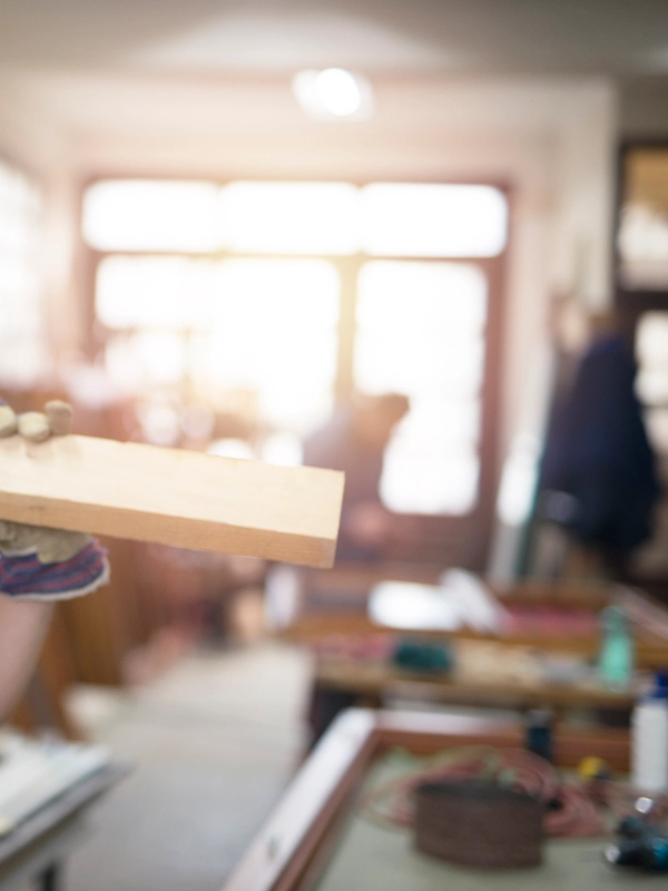 Portrait professional carpenter holding wood plank material his shoulder smiling