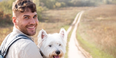 Man holding cute dog medium shot