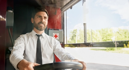 Handsome professional bus driver steering wheel sitting cabin work front view smiling