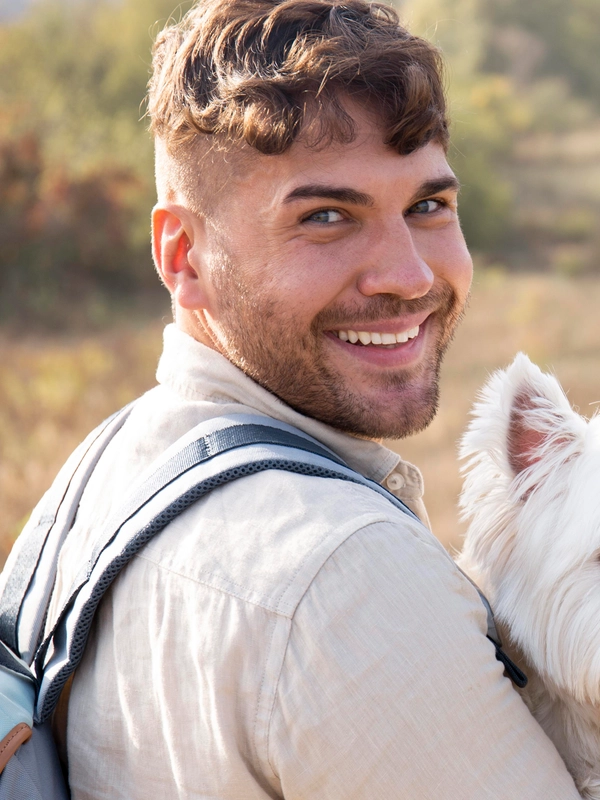 Man holding cute dog medium shot