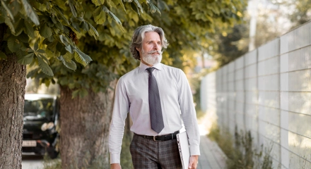 Front view senior male walking outdoors