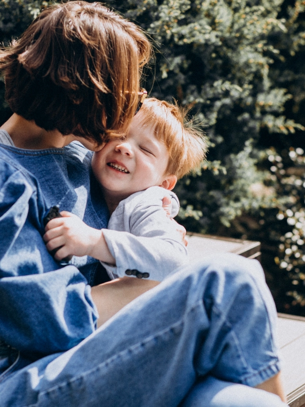 Mother with her son sitting stairs