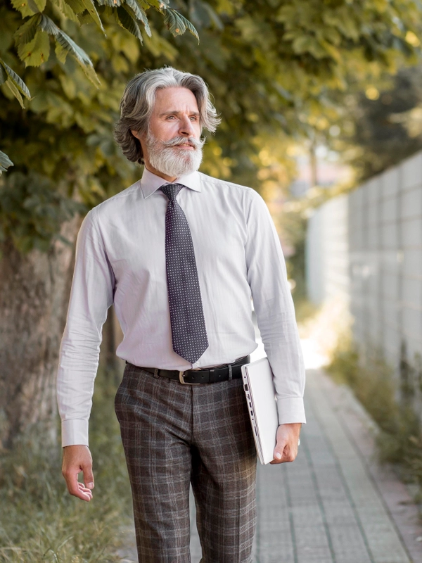 Front view senior male walking outdoors