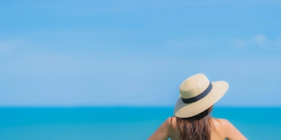 Portrait beautiful young asian woman happy smile relax swimming pool hotel resort neary sea ocean beach blue sky